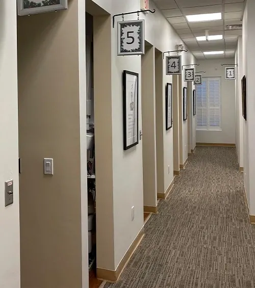 The corridor to the treatment rooms, each door numbered.