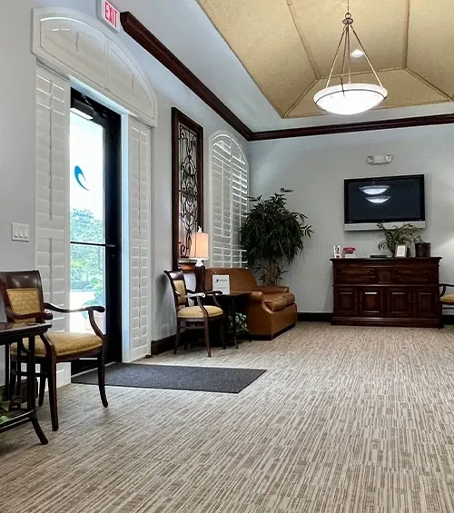 The lobby, with its wrought-iron window screens, pendant light and reception desk.